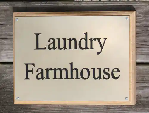 Engraved brass plaque on wooden plinth