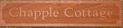 Sapele cottage sign with raised design